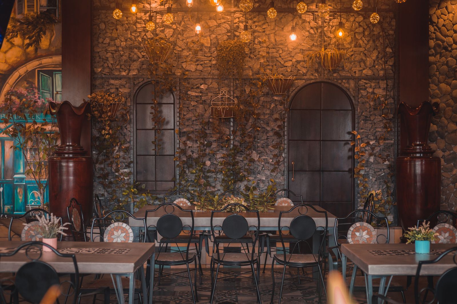 Charming dining area featuring rustic stone walls and ambient lighting, perfect for a cozy meal.